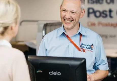 A customer being helped at an Isle of Man Post counter