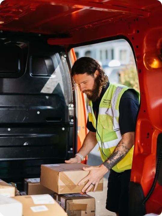 A postal worker preparing parcels for delivery